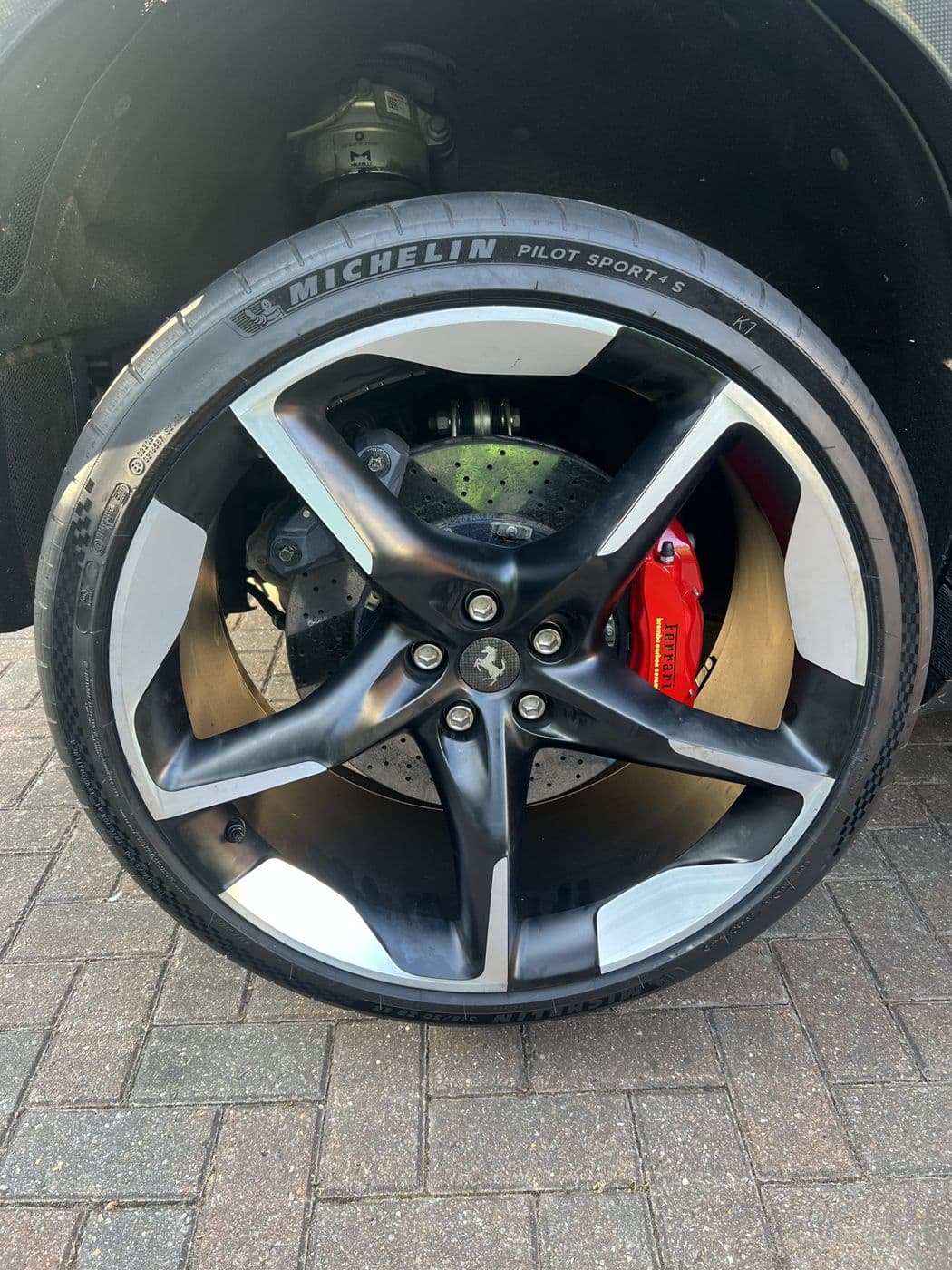 Close-up of a prestige alloy wheel with a Michelin Pilot Sport tyre and a red brake caliper