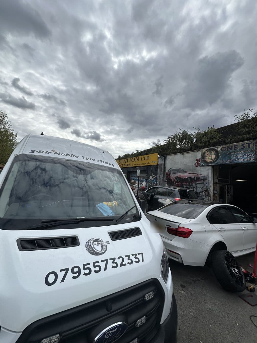 Front of a white JL Mobile Tyres van with 07955 732337 printed on the bonnet